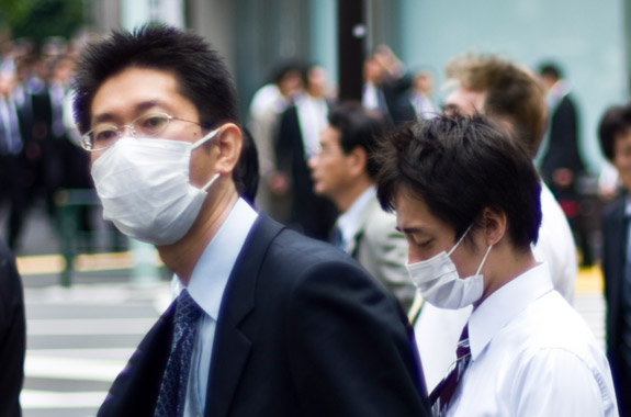 Businessmen protect themselves from an H1N1 outbreak on a Tokyo street